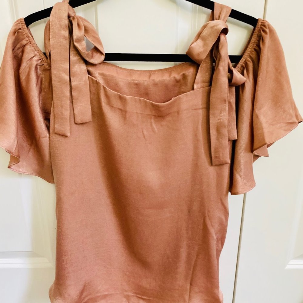 Cold shoulder top with bow tie straps.